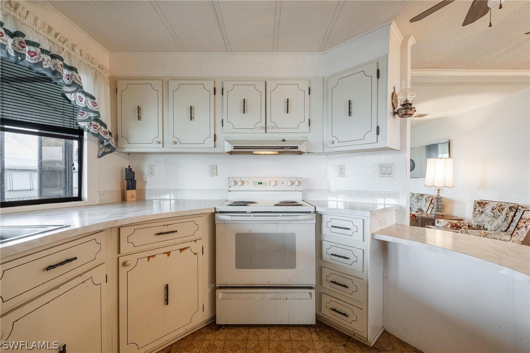 27 Aloe Alva, FL 33920 - Photo 5 of 33 a kitchen with cabinets appliances a sink and a counter top