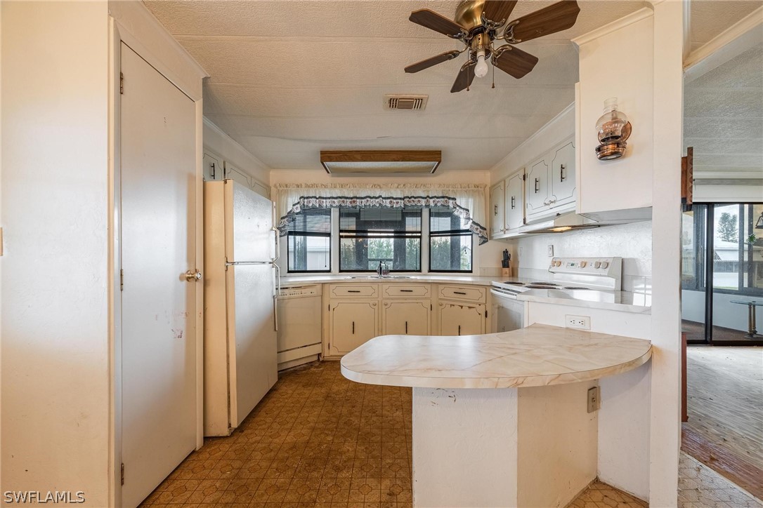 27 Aloe Alva, FL 33920 - Photo 7 of 33 a kitchen with kitchen island a large counter top space and stainless steel appliances