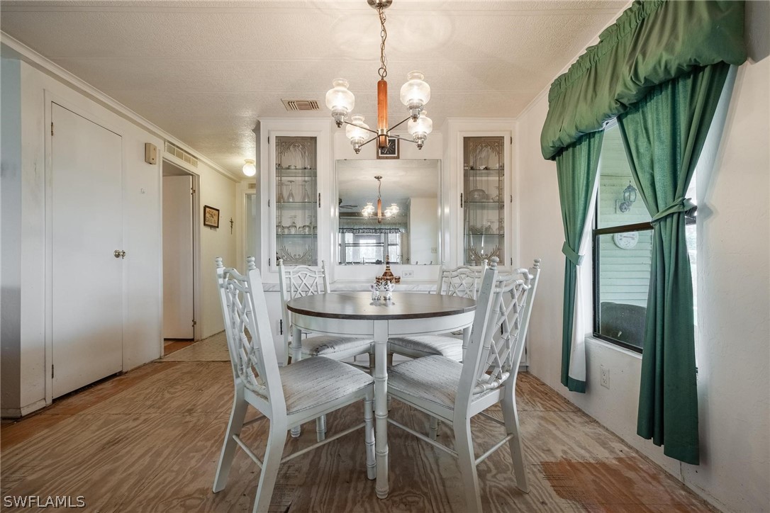 27 Aloe Alva, FL 33920 - Photo 8 of 33 a view of a dining room with furniture and wooden floor