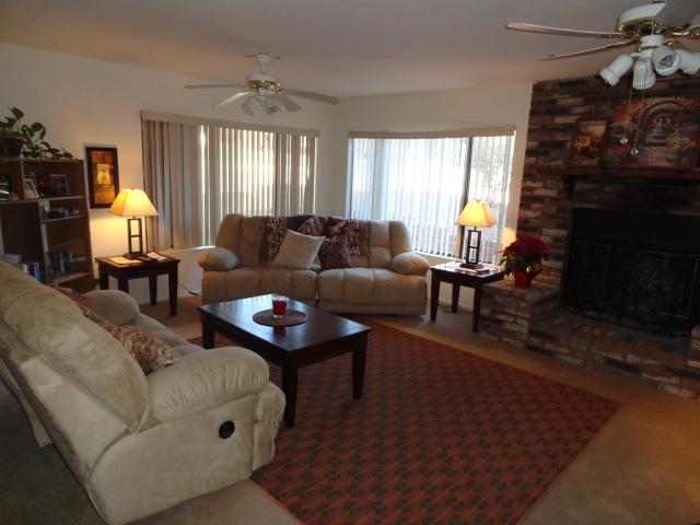 2175 Lariat Road Sedona, AZ 86336 - Photo 3 of 10 a living room with furniture a fireplace and a window