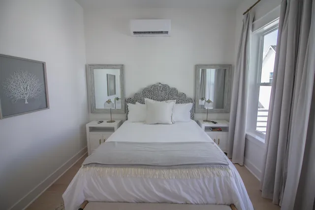 a bedroom with a bed and a mirror