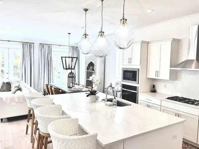 a dining room with wooden floor and glass windows
