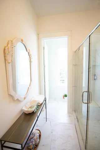 a bathroom with a shower and a sink a mirror
