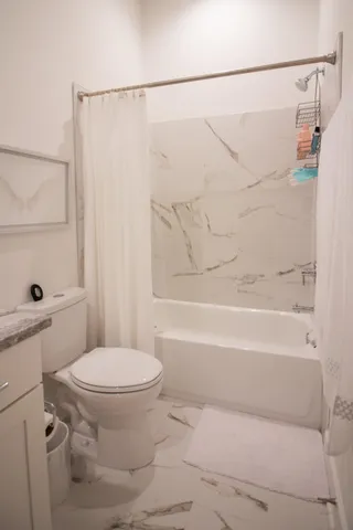 a bedroom with a large bed and a window