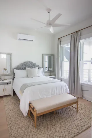 a view of a house with a yard and palm trees