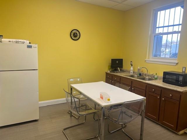 568 Merchant Street Ambridge, PA 15003 - Photo 10 of 20 a kitchen with a table chairs and a refrigerator