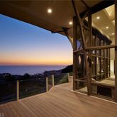 a view of a balcony with wooden floor and a potted plant