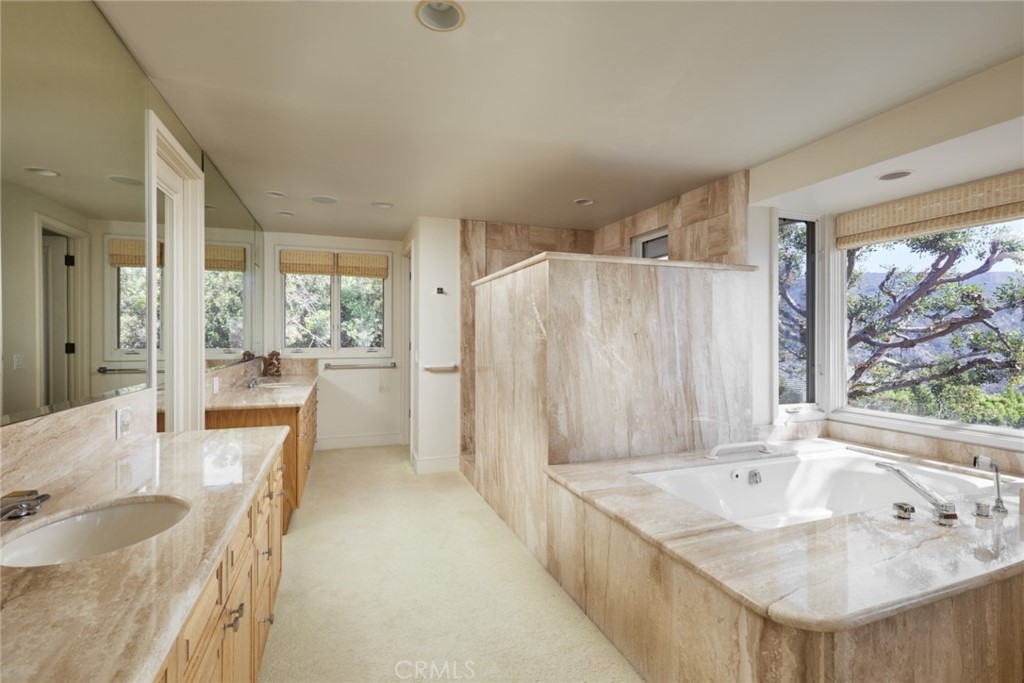 1513 Emerald Bay Laguna Beach, CA 92651 - Photo 32 of 44 a bathroom with a granite countertop sink and a large mirror