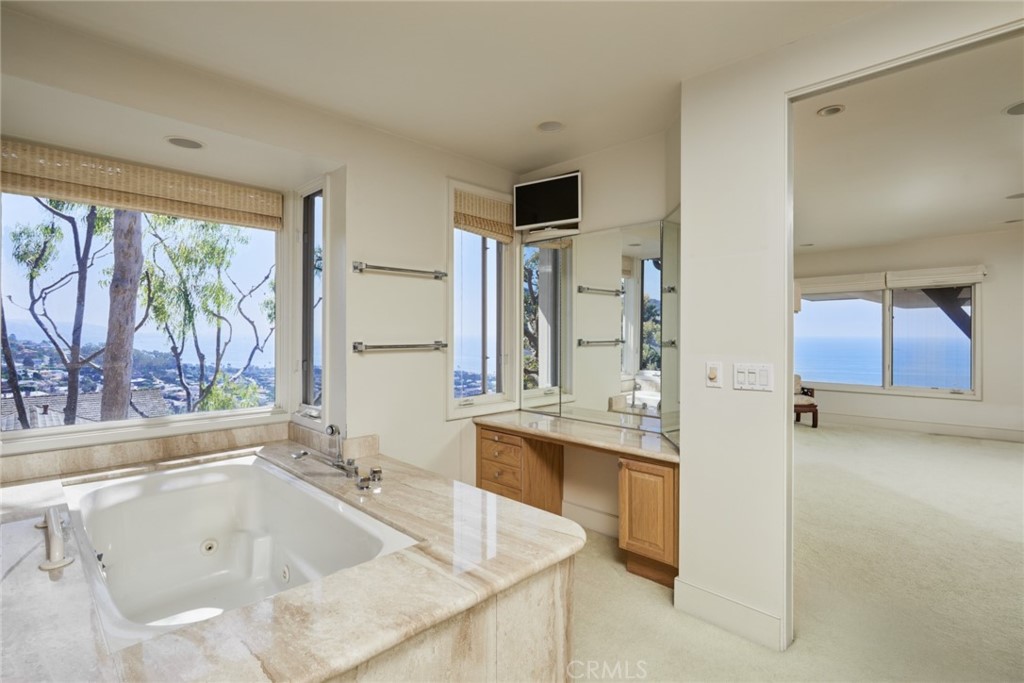 1513 Emerald Bay Laguna Beach, CA 92651 - Photo 33 of 44 a bathroom with a tub sink and mirror