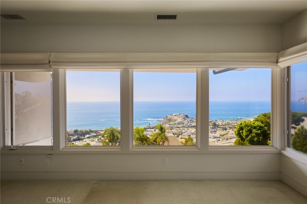 1513 Emerald Bay Laguna Beach, CA 92651 - Photo 34 of 44 a bathroom with a large window and a bathtub