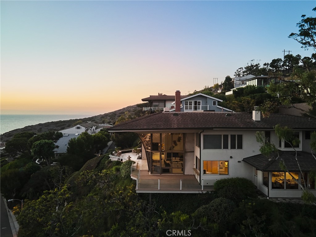 1513 Emerald Bay Laguna Beach, CA 92651 - Photo 40 of 44 a front view of a house with a garden and sitting area