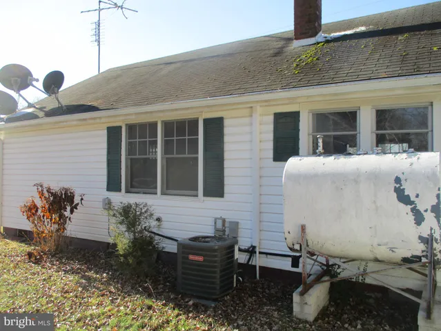 a front view of a house with outdoor seating