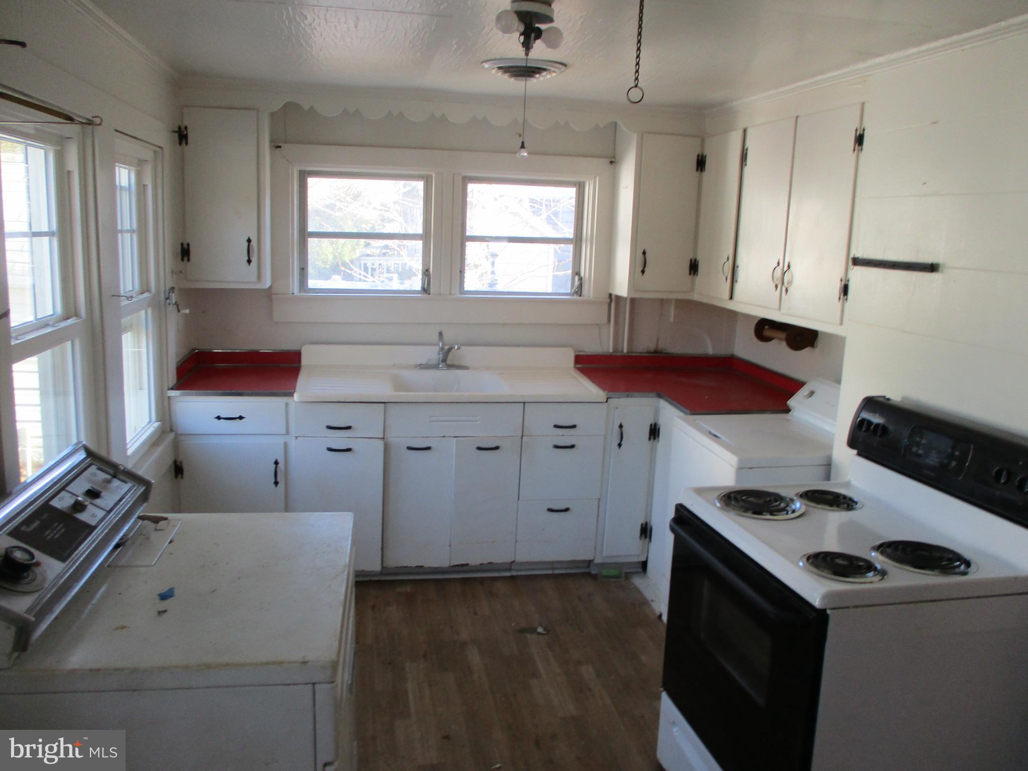 6369 Neavitt Manor Road Neavitt, MD 21652 - Photo 4 of 10 a kitchen with a stove and a refrigerator