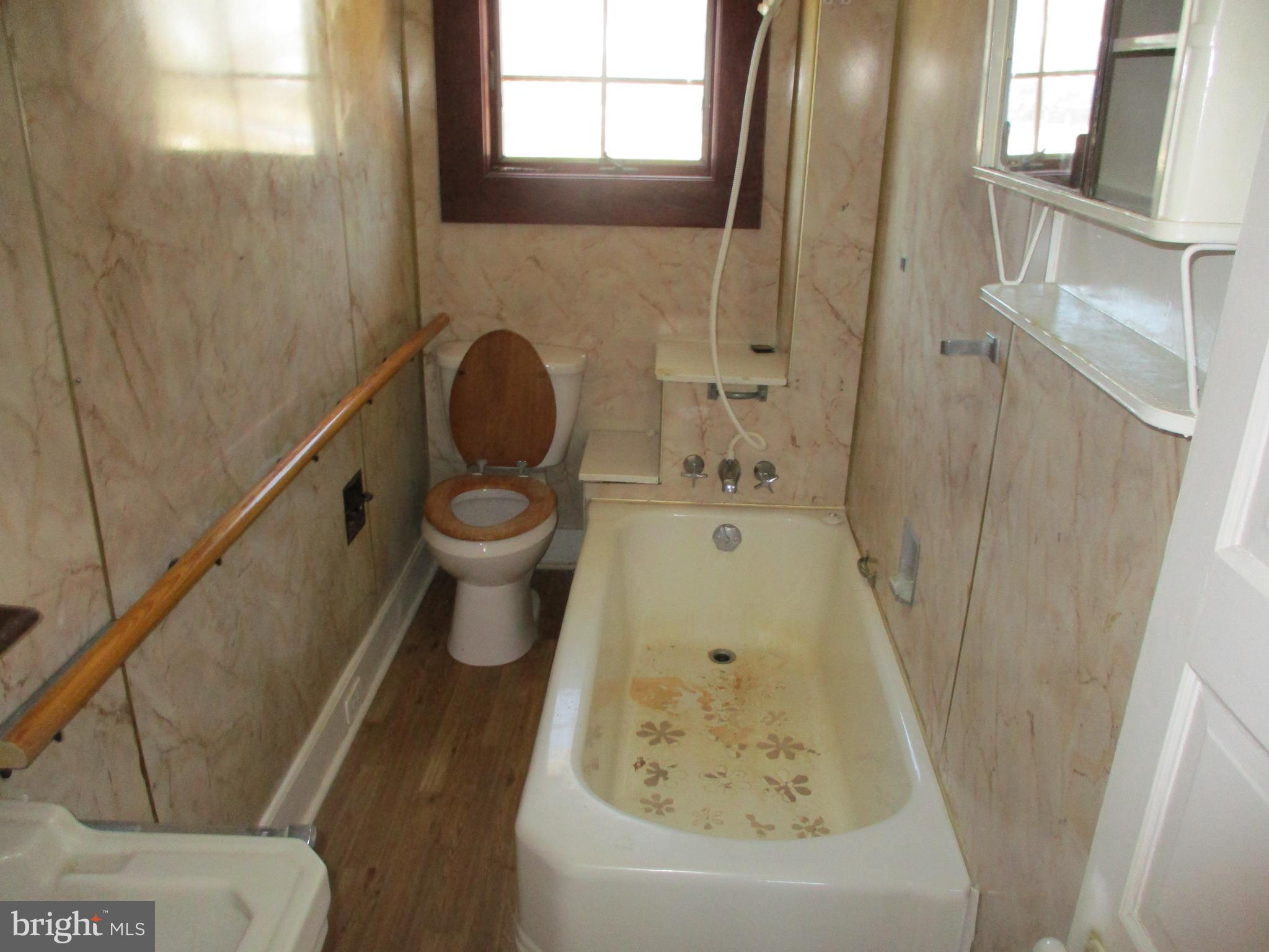 6369 Neavitt Manor Road Neavitt, MD 21652 - Photo 6 of 10 a bathroom with a granite countertop sink toilet and shower