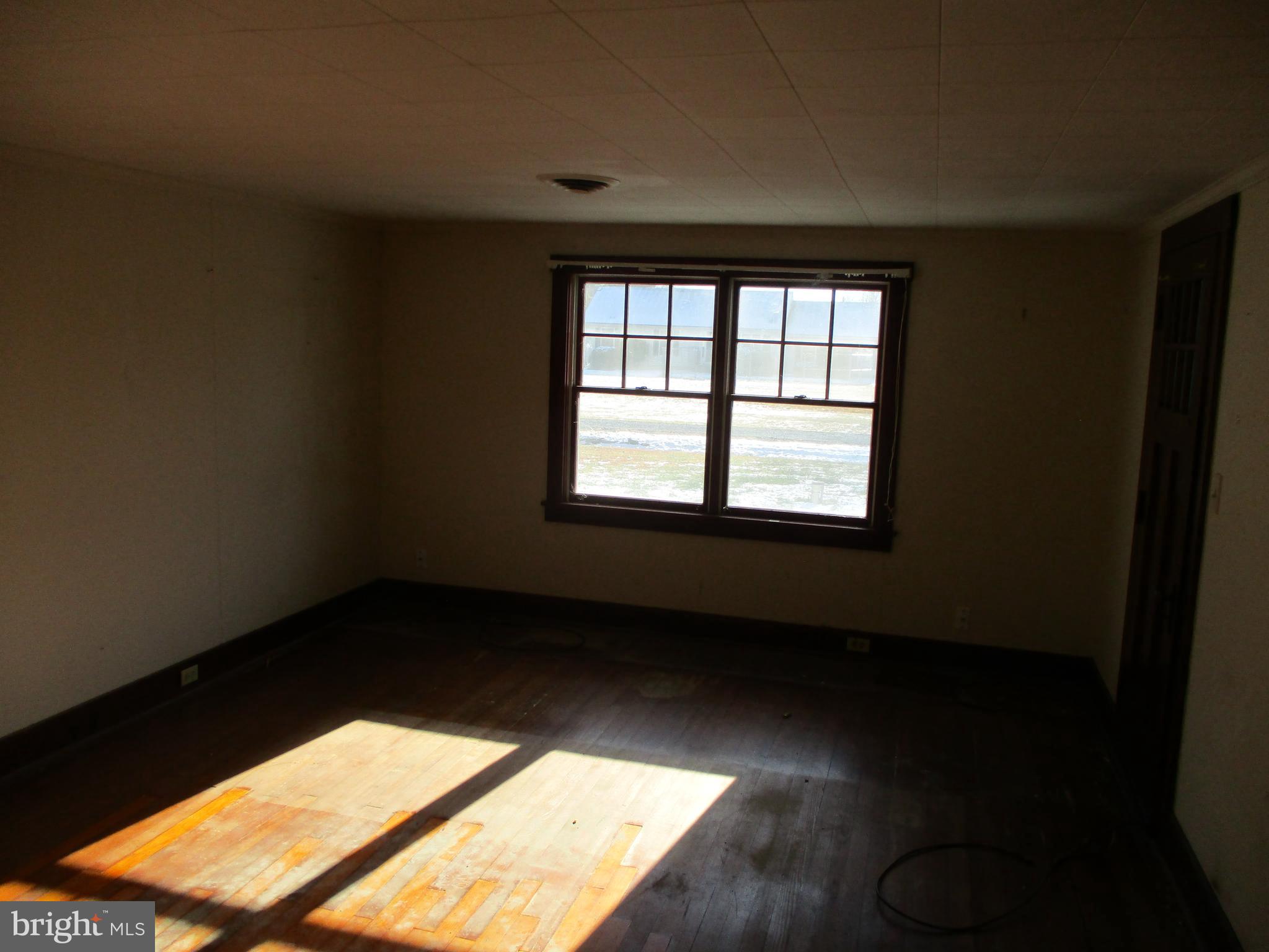 6369 Neavitt Manor Road Neavitt, MD 21652 - Photo 7 of 10 a view of an empty room with a window