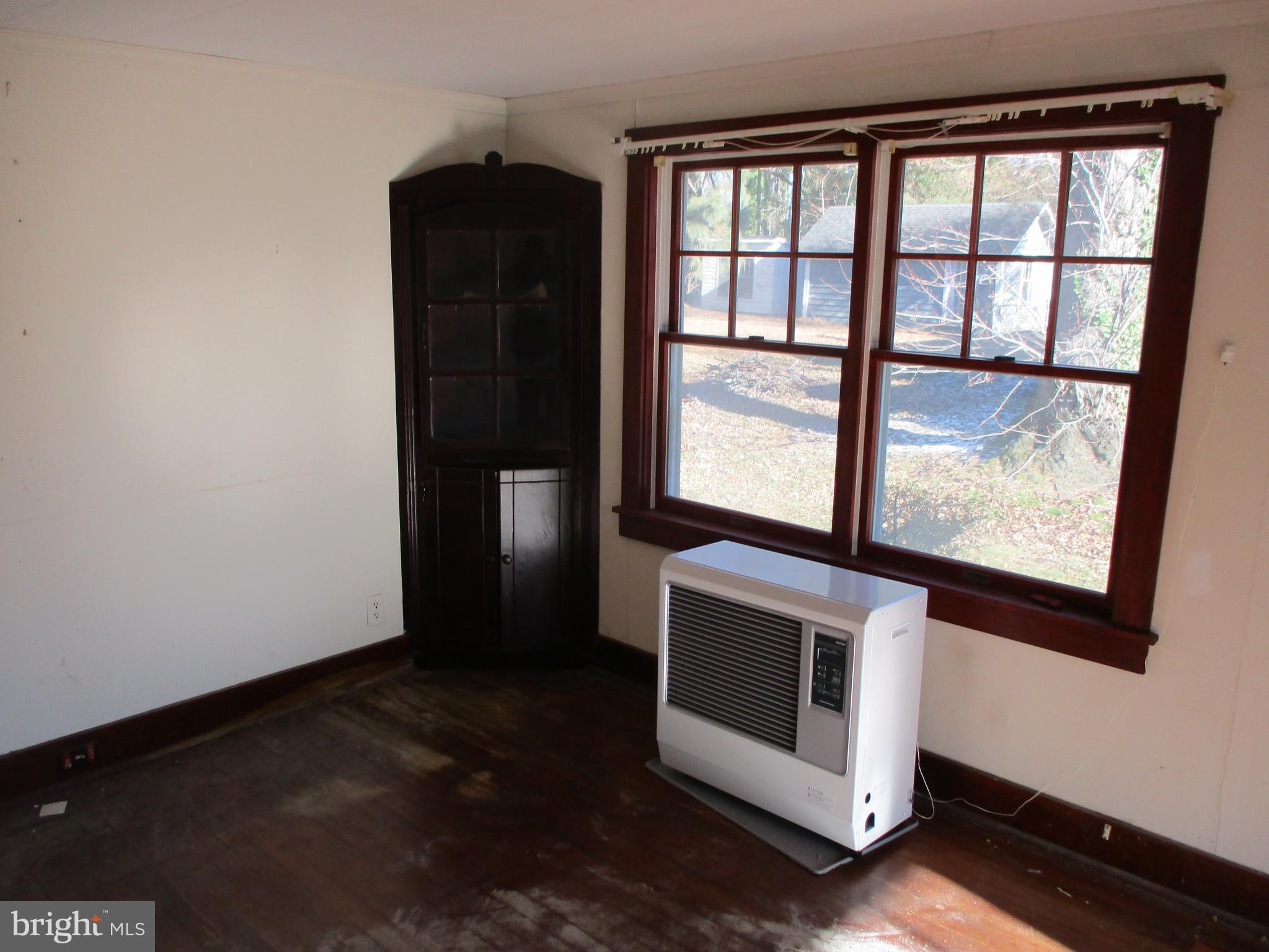 6369 Neavitt Manor Road Neavitt, MD 21652 - Photo 8 of 10 a view of an empty room with wooden floor and a window