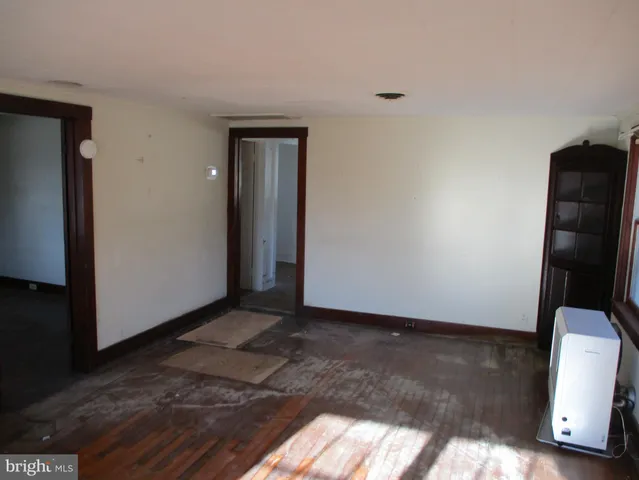 a view of an empty room and wooden floor