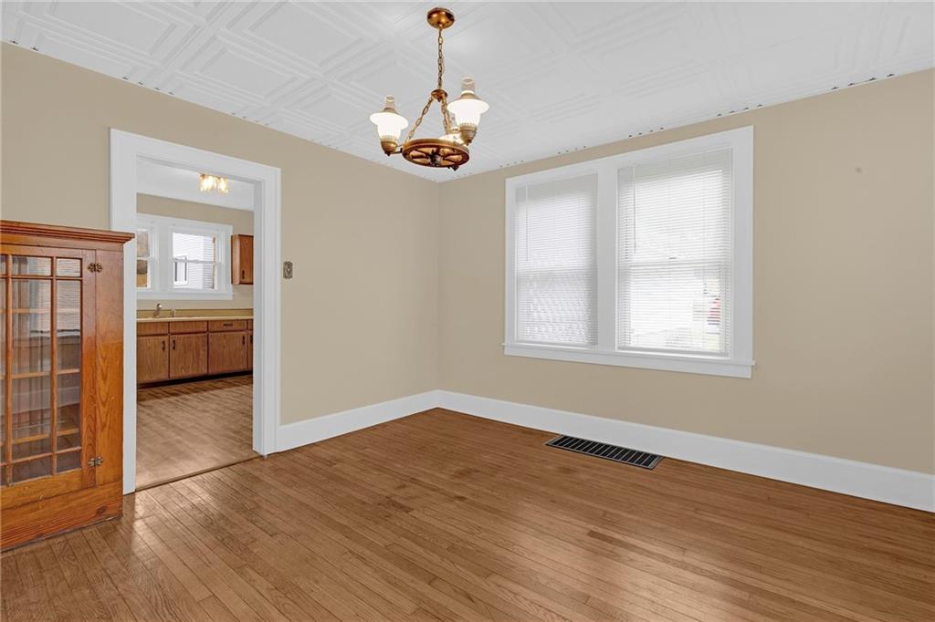545 Virginia Avenue Rochester, PA 15074 - Photo 3 of 21 a view of a room with wooden floor chandeliers and kitchen view