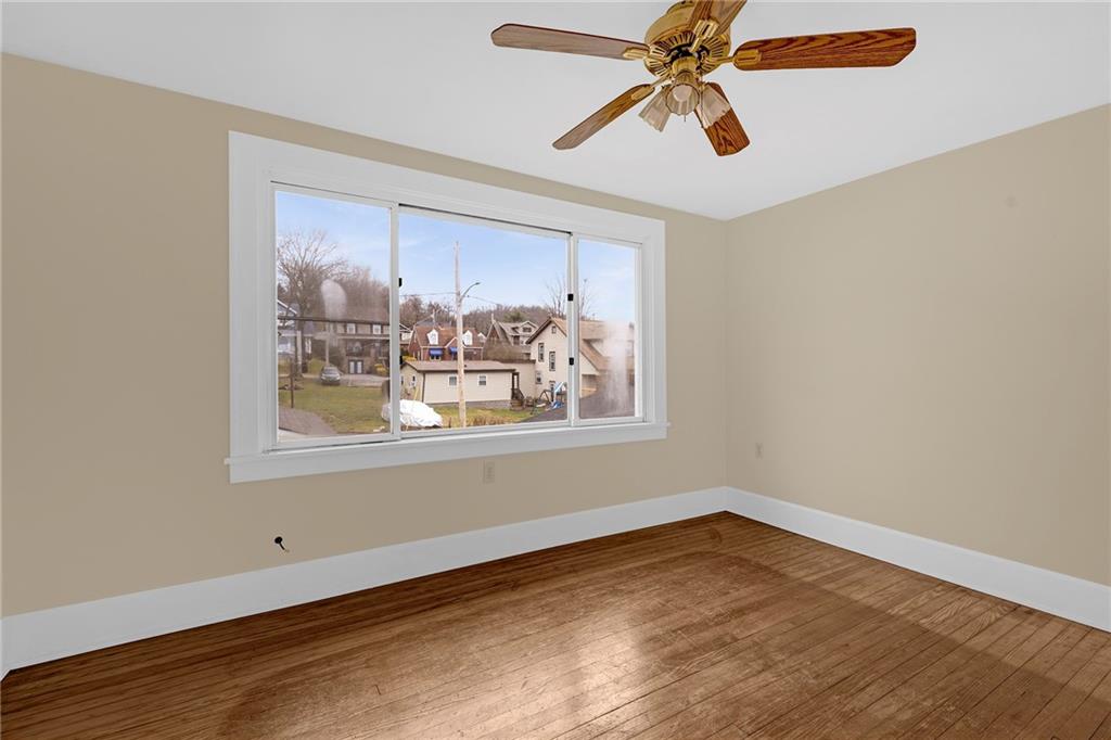 545 Virginia Avenue Rochester, PA 15074 - Photo 10 of 21 a view of a big room with wooden floor and windows