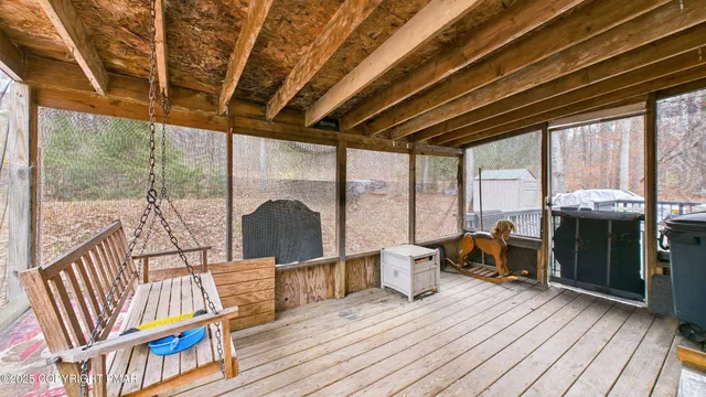 a view of deck with a table and chairs and wooden floor