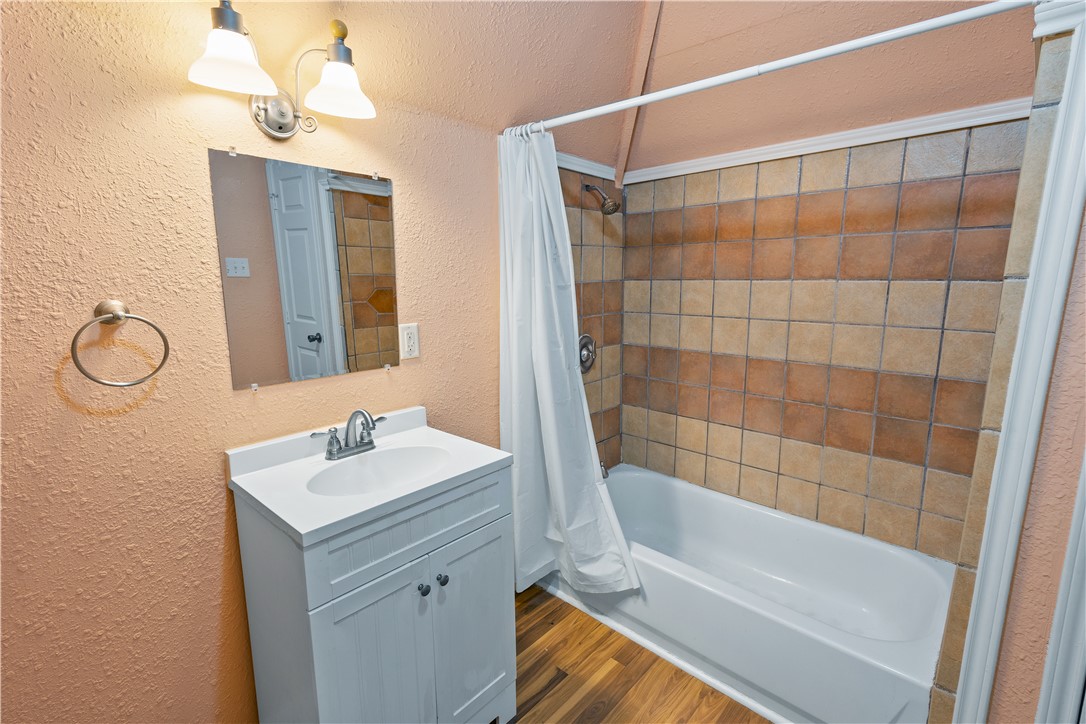 500 North Washington Avenue Bryan, TX 77803 - Photo 14 of 15 a bathroom with a tub sink vanity and mirror