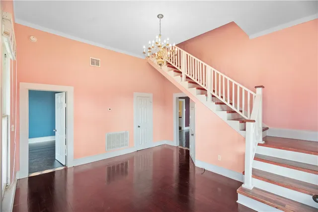 a view of entryway and hall with wooden floor