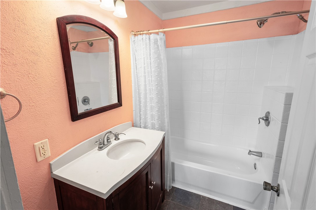500 North Washington Avenue Bryan, TX 77803 - Photo 5 of 15 a bathroom with a sink vanity tub and a mirror