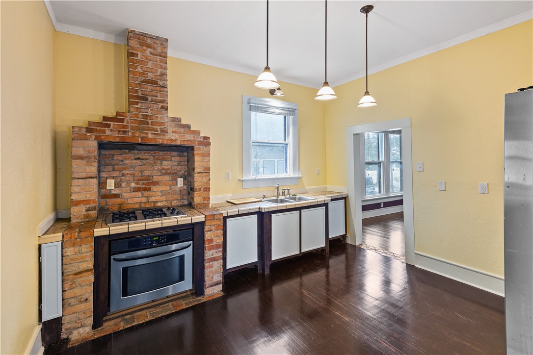 500 North Washington Avenue Bryan, TX 77803 - Photo 8 of 15 a large kitchen with a stove and a wooden floor