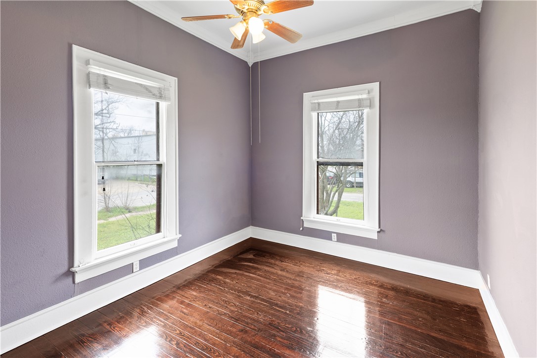 500 North Washington Avenue Bryan, TX 77803 - Photo 10 of 15 a view of an empty room with wooden floor and a window