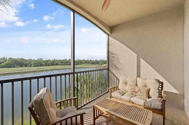 a swimming pool with outdoor seating and lake view
