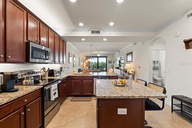 a kitchen with stainless steel appliances granite countertop a sink and cabinets