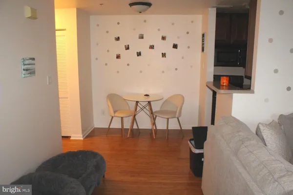 a dining room with furniture and wooden floor