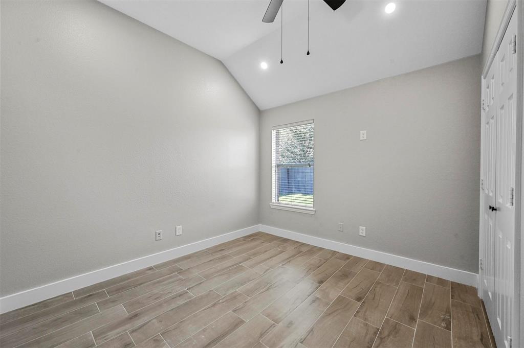 2667 Lake Ridge Drive Little Elm, TX 75068 - Photo 11 of 17 wooden floor in an empty room with a window