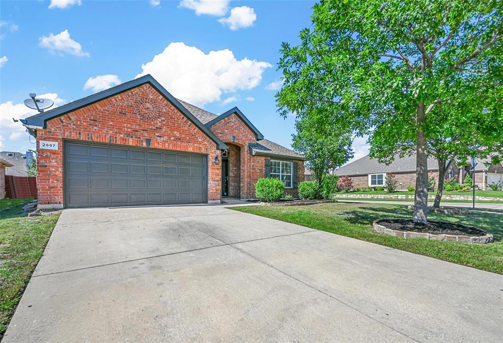 2667 Lake Ridge Drive Little Elm, TX 75068 - Photo 17 of 17 a front view of a house with garden