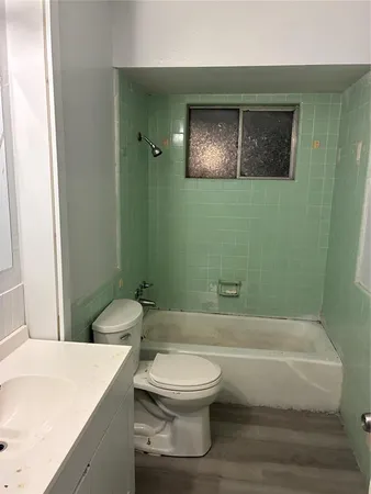 a bathroom with a toilet a sink and bathtub