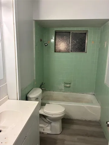 a bathroom with a toilet a sink and bathtub