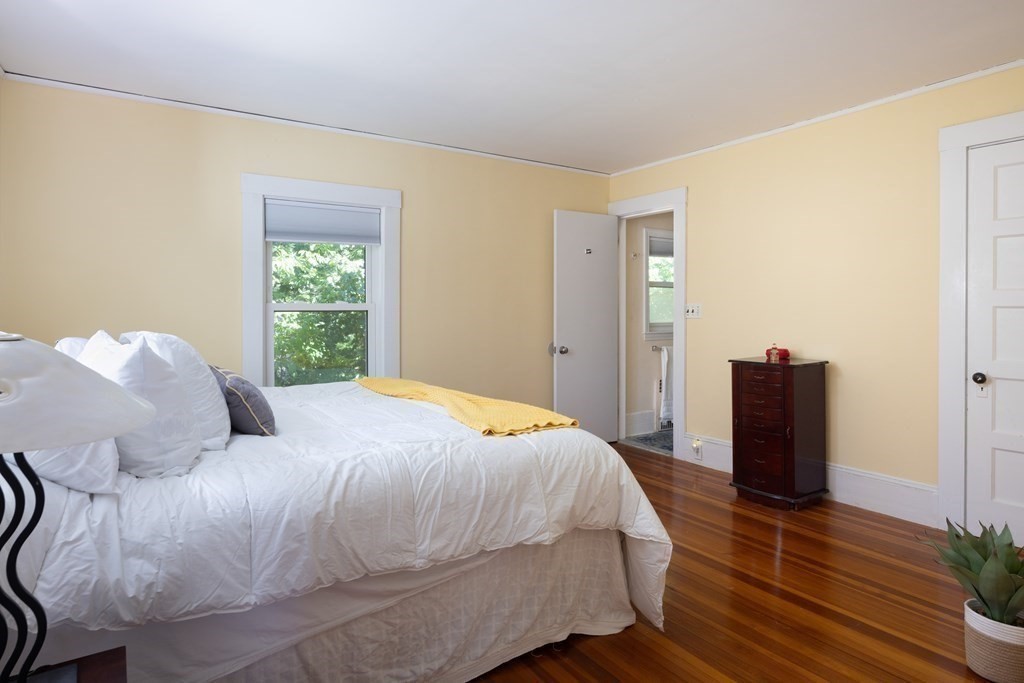 9 Belfry Terrace Lexington, MA 02421 - Photo 12 of 23 a bedroom with a bed and wooden floor