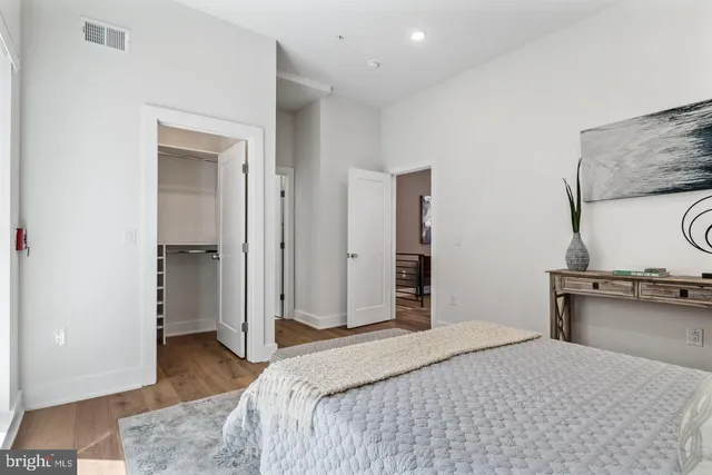 a bedroom with a bed and a dresser