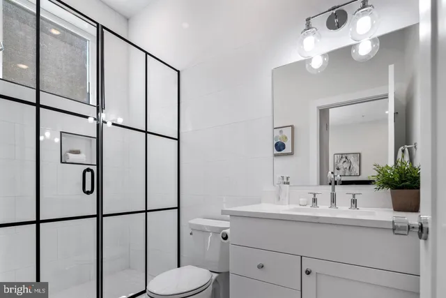 a bathroom with a shower sink and mirror