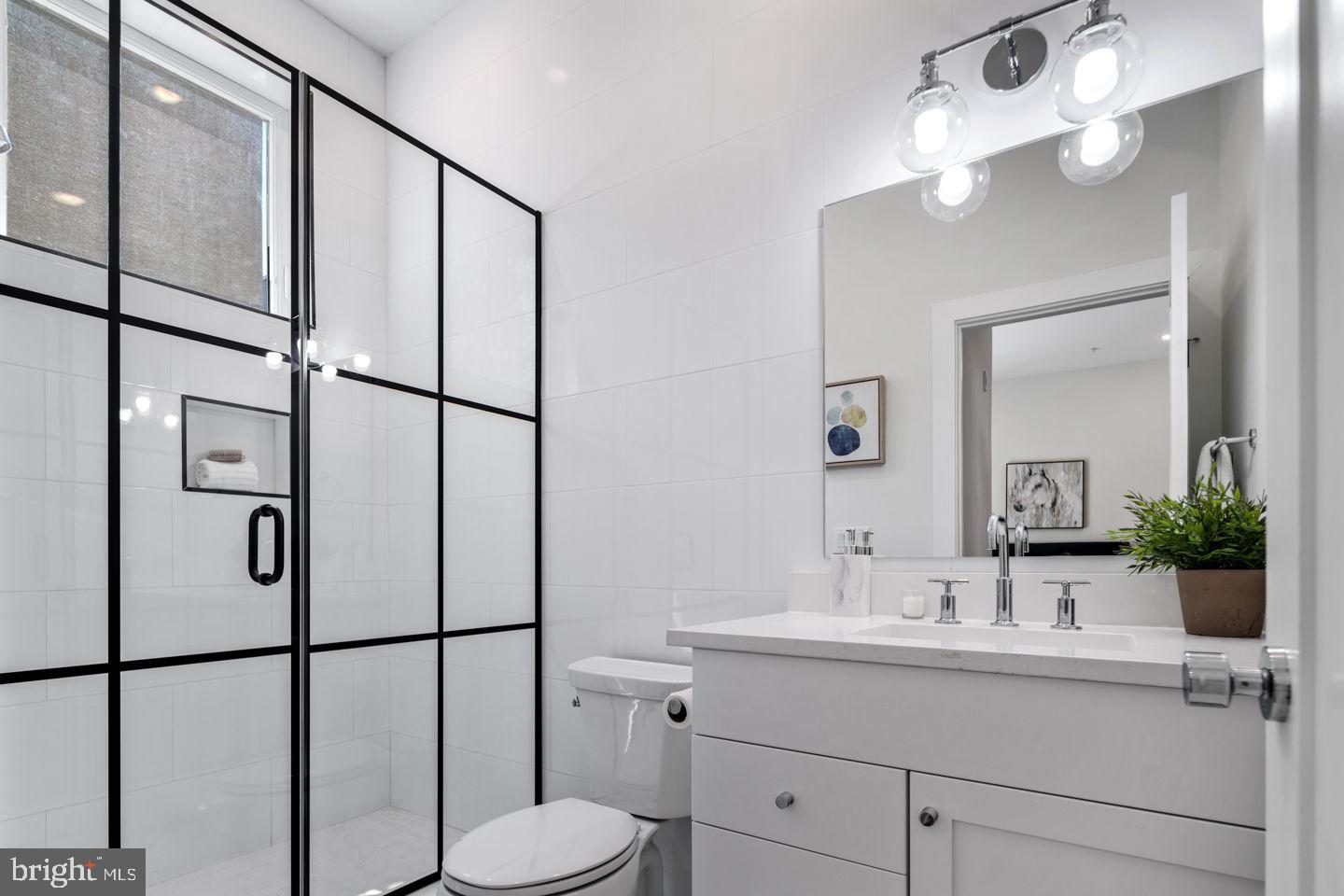 1910 Brown Street Philadelphia, PA 19130 - Photo 13 of 31 a bathroom with a shower sink and mirror