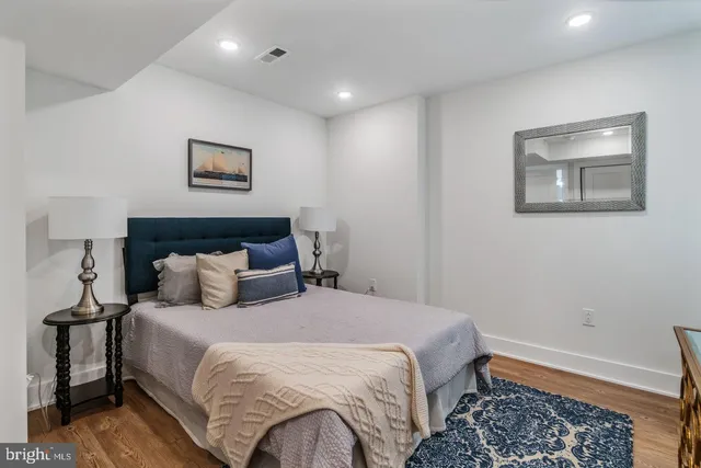 a bedroom with bed and wall painting