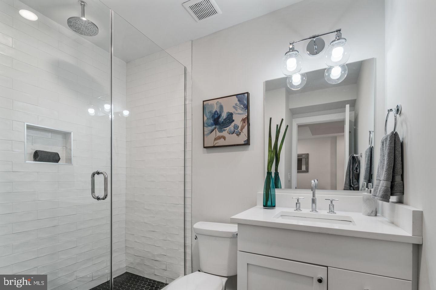 1910 Brown Street Philadelphia, PA 19130 - Photo 19 of 31 a bathroom with a sink a toilet and a mirror