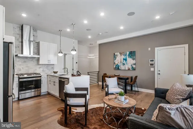 a large kitchen with a table and chairs