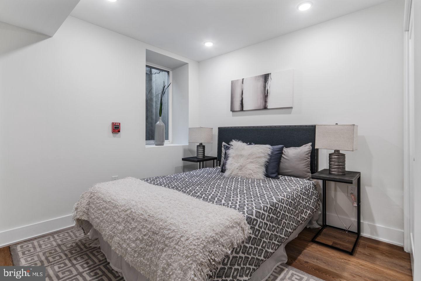 1910 Brown Street Philadelphia, PA 19130 - Photo 22 of 31 a bedroom with a large bed and a painting on the wall