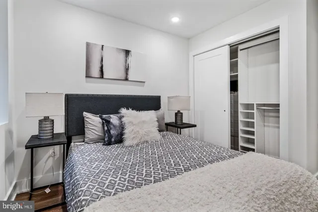 a bedroom with a bed and wooden floor