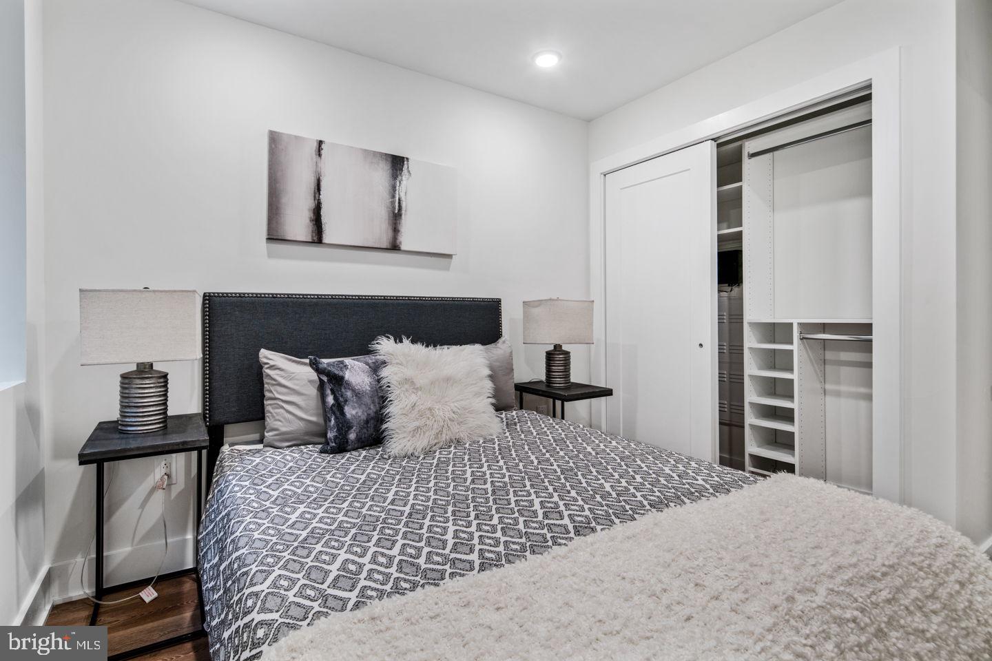 1910 Brown Street Philadelphia, PA 19130 - Photo 23 of 31 a bedroom with a bed and wooden floor