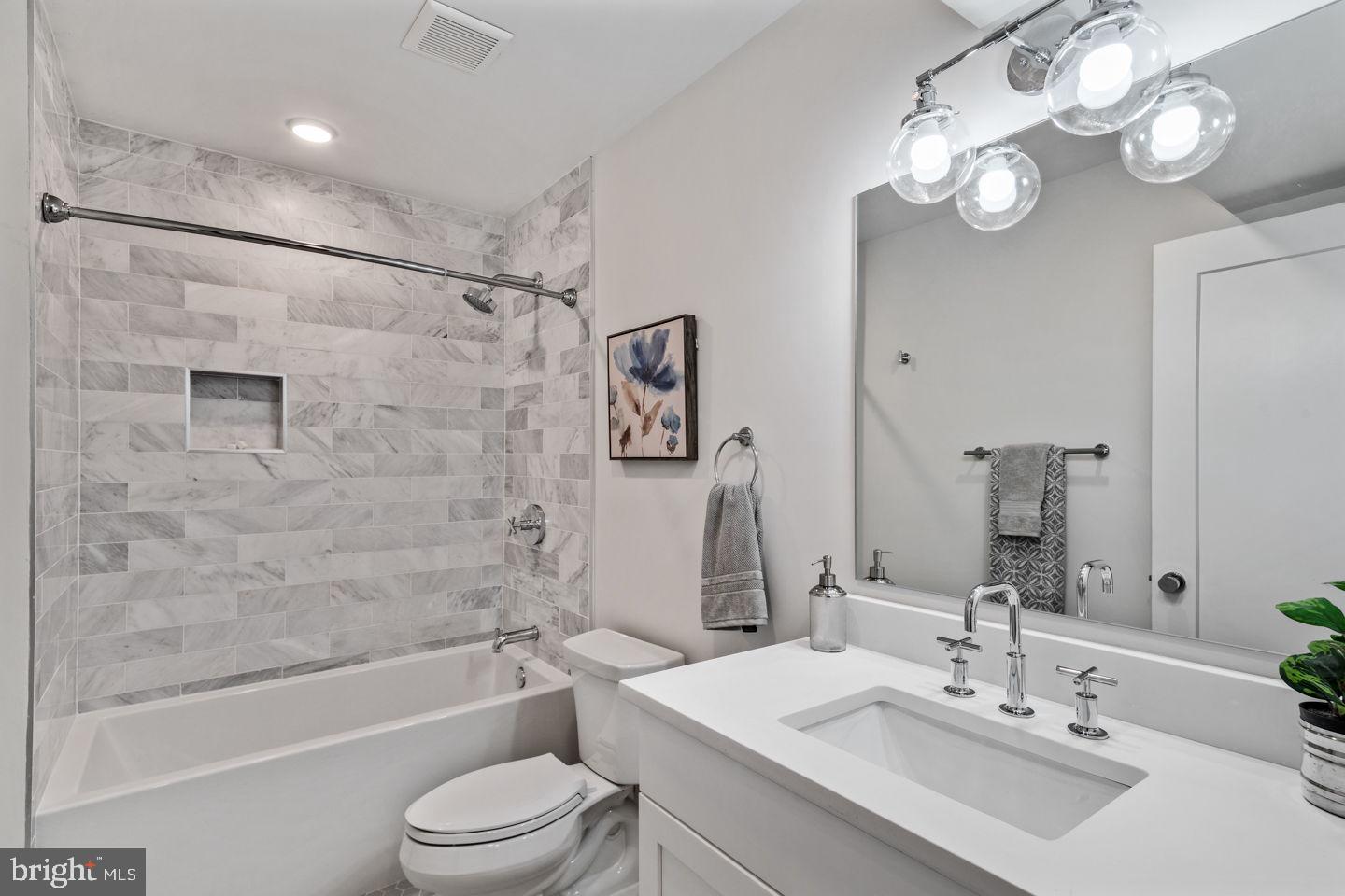 1910 Brown Street Philadelphia, PA 19130 - Photo 25 of 31 a bathroom with a toilet a sink a mirror a bathtub and shower