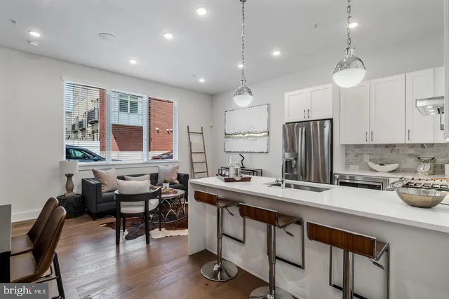 a kitchen with sink cabinets and wooden floor