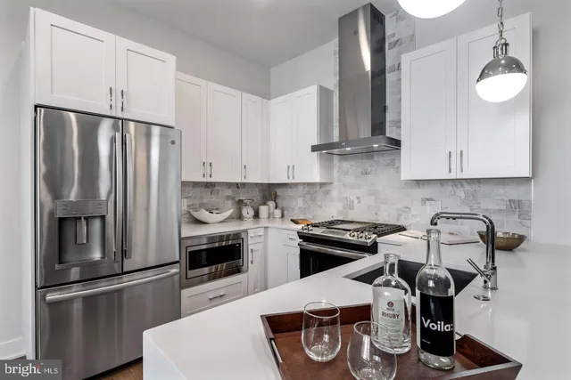 a kitchen with a refrigerator and a stove