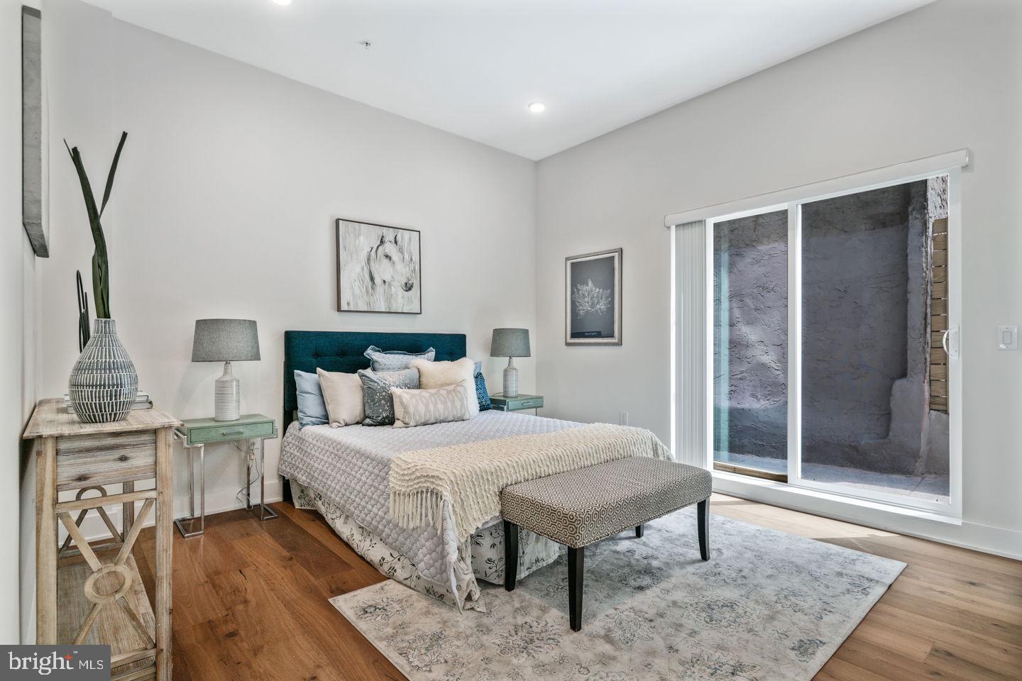 1910 Brown Street Philadelphia, PA 19130 - Photo 10 of 31 a bedroom with a bed and a table